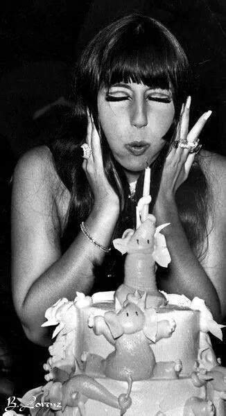 Cher blows out the candles on her birthday cake. Cher Birthday, Happy ...