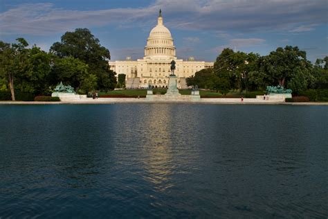 White Dome Building Near Green Trees and Body of Water · Free Stock Photo