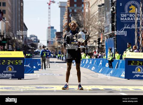 Evans Chebet, of Kenya, holds the trophy after winning the 126th Boston Marathon, Monday, April ...