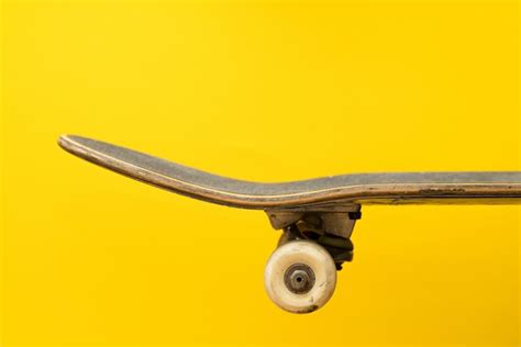 Premium Photo | Professional skateboard on yellow surface side view.