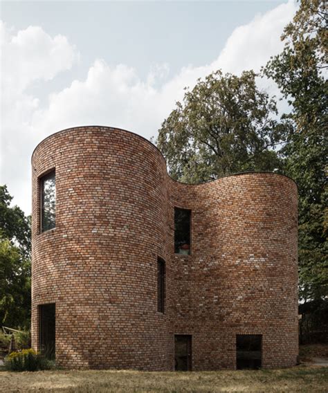 BLAF architects uses recycled bricks to build curved 'gjG house' in belgium