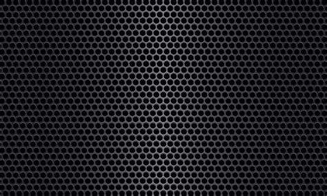 Black metal texture steel background. The pattern metal sheet is perforated with a flash of ...