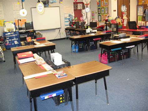 My classroom desk arrangement with table tags and crate book cases for supplies. | Classroom ...