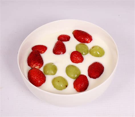 Yogurt with strawberries and green grapes toppings