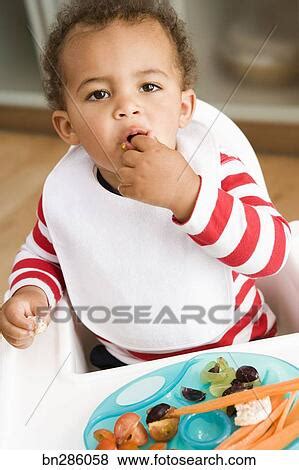 Baby eating vegetables Stock Photo | bn286058 | Fotosearch