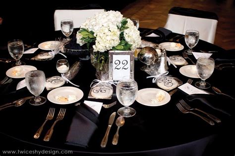 Black tablecloth with white flowers and silver reflections. Black ...