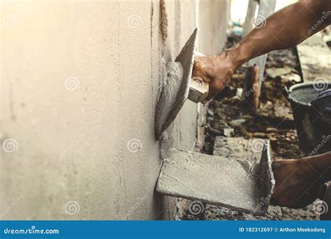 Close-up of Workers Using Plaster Trowel To Plaster the Walls for House Construction. Stock ...