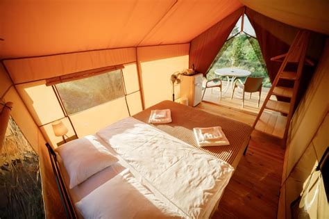 Premium Photo | Interior of cozy open glamping tent with light inside ...