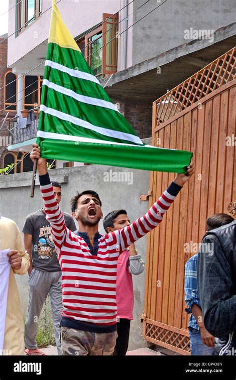 A Kashmiri protester raises a pro Kashmir flag during anti India and ...