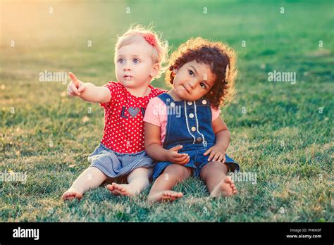 Group portrait of two cute adorable girls toddlers children sitting ...