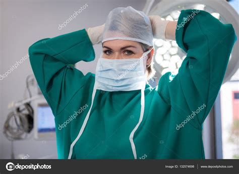 Female surgeon wearing surgical mask Stock Photo by ©Wavebreakmedia ...