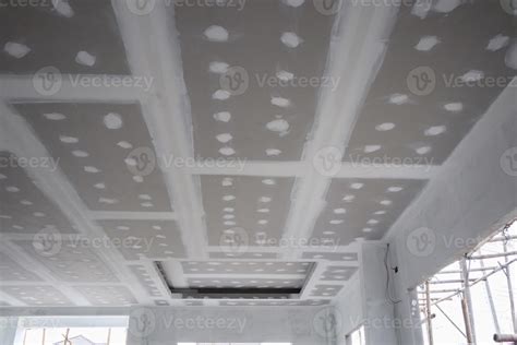 ceiling gypsum board installation at construction site 12806004 Stock Photo at Vecteezy