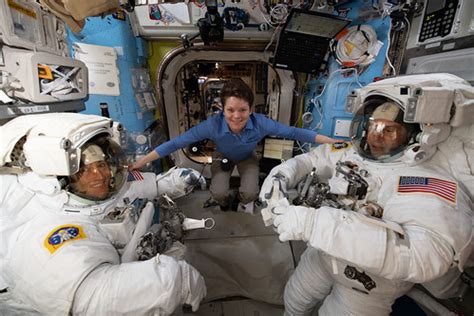 Astronaut Anne McClain assists fellow astronauts Christina… | Flickr