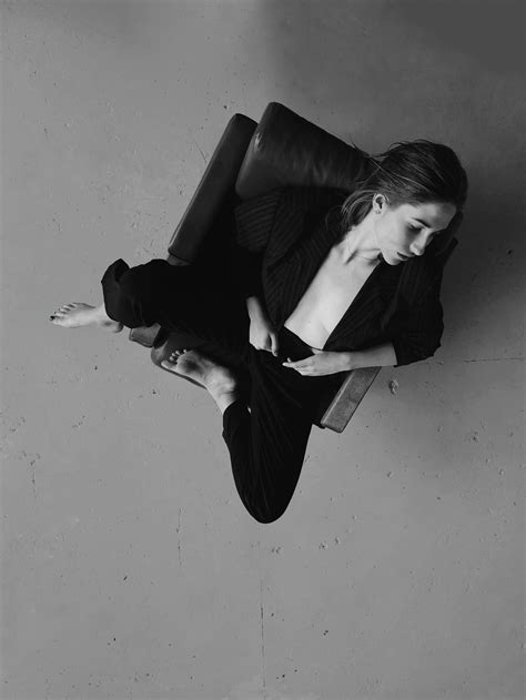 Woman in Black Blazer Sitting on Black Leather Sofa · Free Stock Photo