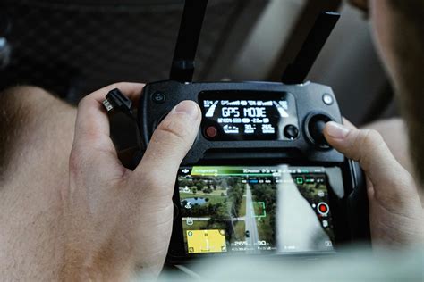 Person Controlling Drone Using Black Remote Control · Free Stock Photo