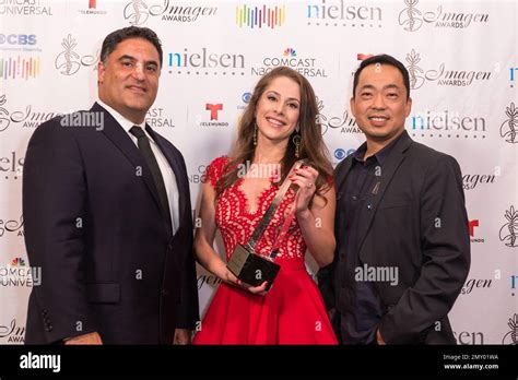 Cenk Uygur, left, Ana Kasparian, and Steve Oh pose with the 2016 Vision award for "The Young ...