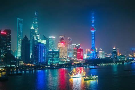 Aerial panoramic view over a big modern city by night. Shanghai, China. Nighttime skyline with ...