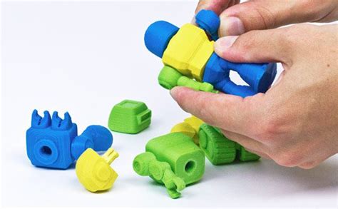 a person is playing with plastic toys on a white surface and there are ...