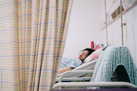 "Expectant Pregnant Woman In Hospital Bed" by Stocksy Contributor "Pansfun Images" - Stocksy