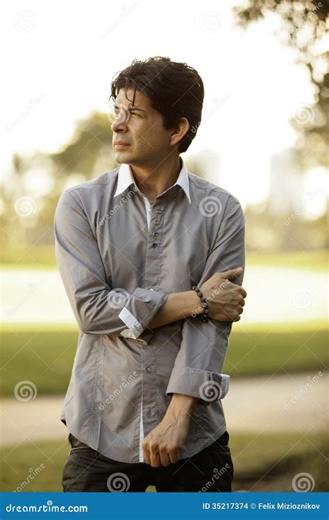 Man holding his arm stock photo. Image of backlit, outdoors - 35217374