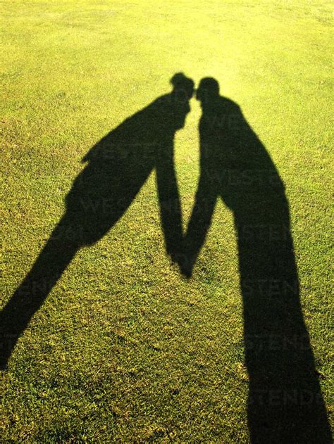 Shadow of couple kissing stock photo