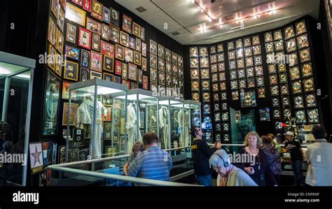 Visitors at the Elvis Presley museum at Graceland with gold records and ...