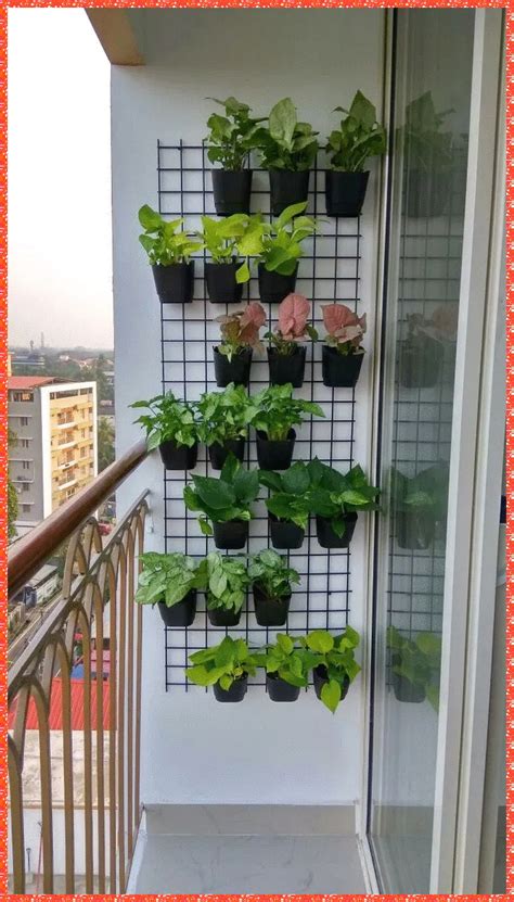 a wall mounted planter on the side of a building with plants growing in it