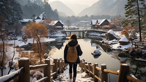 Premium AI Image | Young traveler admires snowy UNESCO village in ...