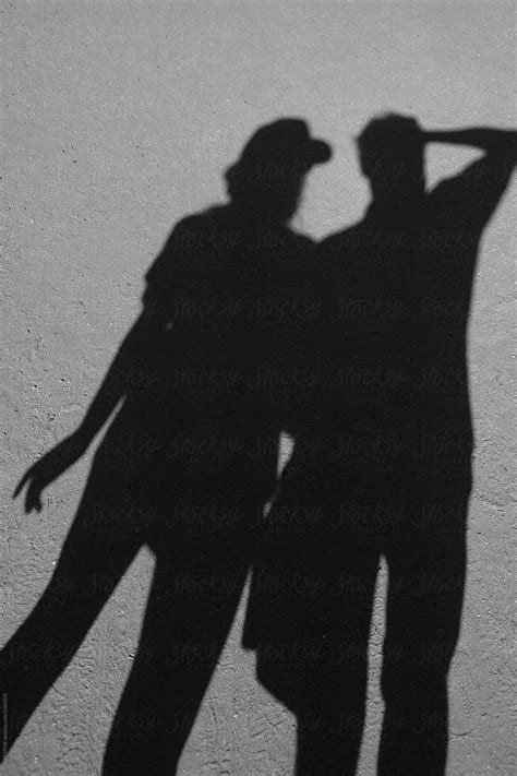 "Shadow Of A Couple Holding Hands." by Stocksy Contributor "RZCREATIVE" - Stocksy