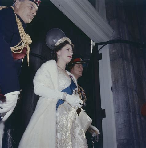 Queen Elizabeth wearing gown, sash and crown in doorway / … | Flickr