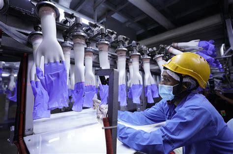 More than 2,400 workers at world's top glove maker test positive for coronavirus - CBS News