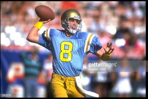 TOMMY MADDOX, QUARTERBACK FOR UCLA, PREPARES TO THROW A PASS DURING ...