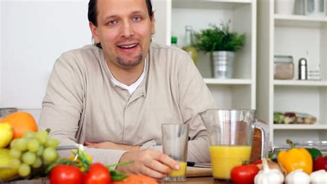 Man Pouring Orange Juice In His Glass In Slow Motion Stock Footage ...