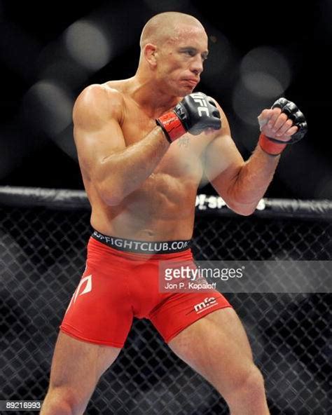 Welterweight Georges St-Pierre battles Thiago Alves during their ...