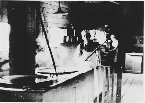 Prisoners labor in the kitchen of the Jasenovac III concentration camp. This photograph was used ...