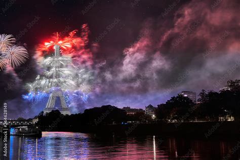 Fireworks show on the eiffel tower displaying the French national flag in celebration of ...