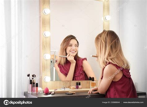 Woman Applying Makeup Mirror Light Bulbs Dressing Room Stock Photo by ©NewAfrica 235886644