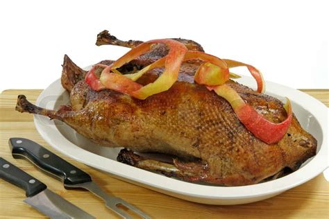 Crunchy roasted goose stuffed with apples on a plate | Stock image | Colourbox