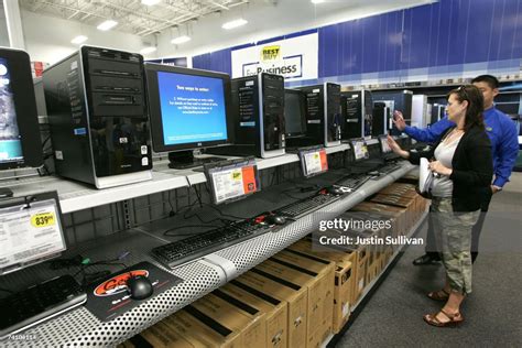 A Best Buy customer looks at a display of HP desktop computers at a ...