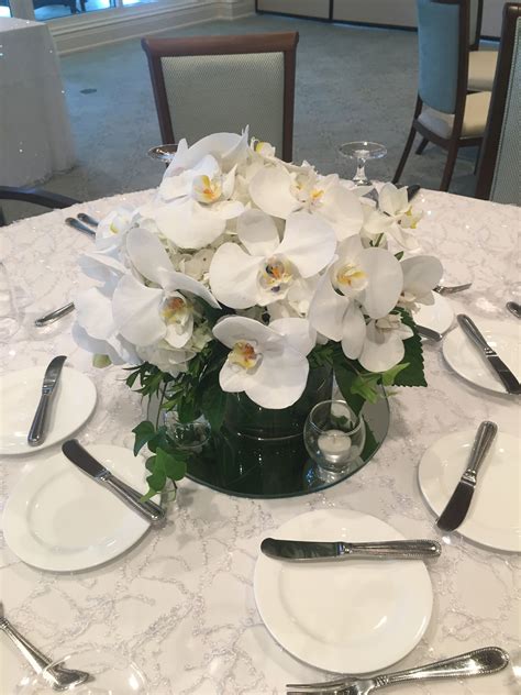 Low white orchid centerpiece | Orchid centerpieces, White orchid centerpiece, Orchid ...