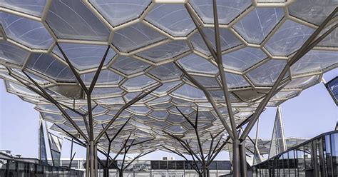 tree-shaped steel columns + organic undulating roof shelter trade show facilities in italy