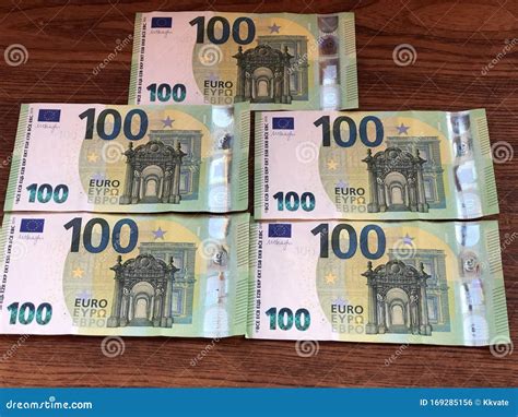 100 Euro Bill. Euro Banknotes in Rows on Wooden Background. EU Currency ...