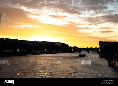 Horizontal photo of a sunset on the Seine river with a typical boat in ...