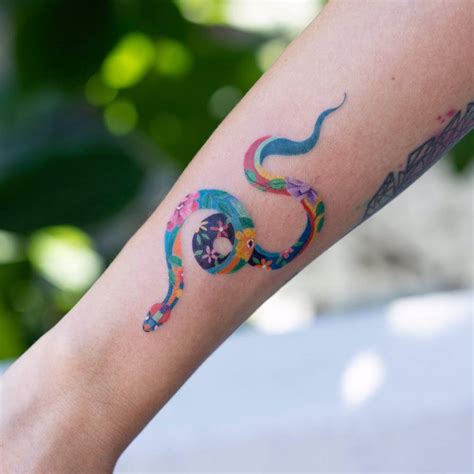 Floral snake tattoo.