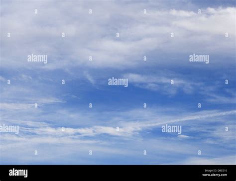 white clouds with airplane trail Stock Photo - Alamy