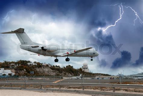 Airplane landing in the storm | Stock image | Colourbox