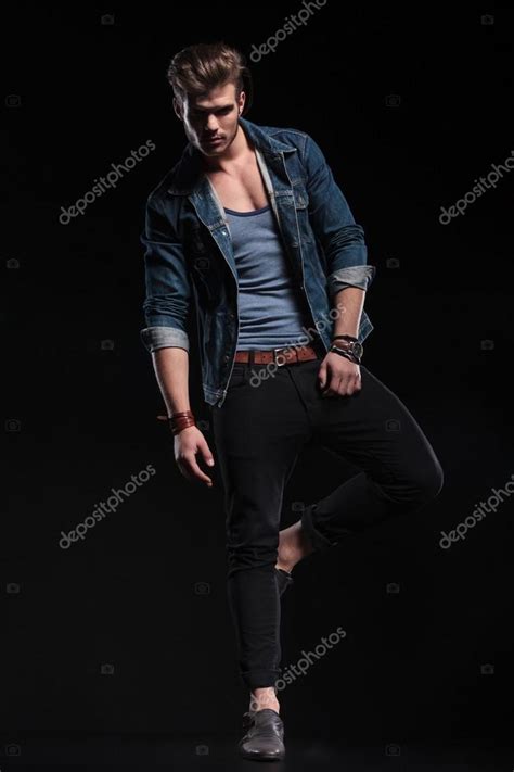 Casual man standing on one leg in a fashion pose — Stock Photo ...