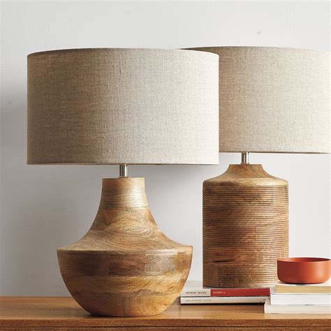 Solid mango wood table lamp, hand carved with rows of dimensional grooves. Natural variations in ...
