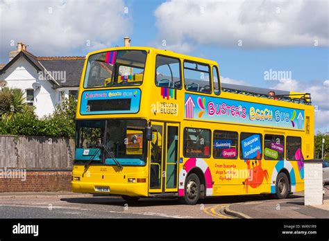 Busters beach bus open top double decker yellow bus stopped at junction at Westbourne ...