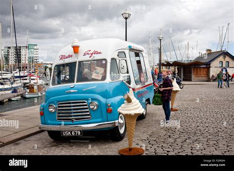 male buying from a Mister softee 1960,s Commer Karrier ice-cream van ...